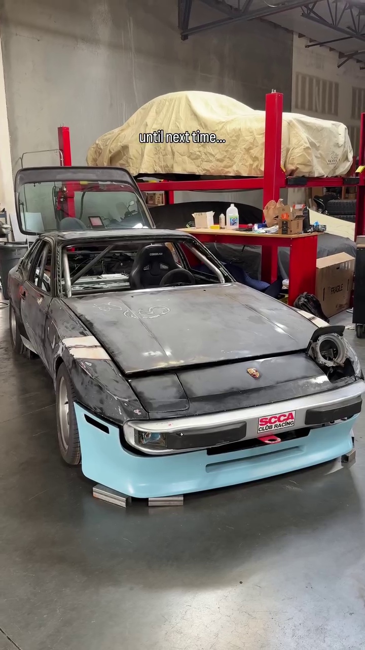 The Porsche 944 racecar project with its roll cage in the workshop